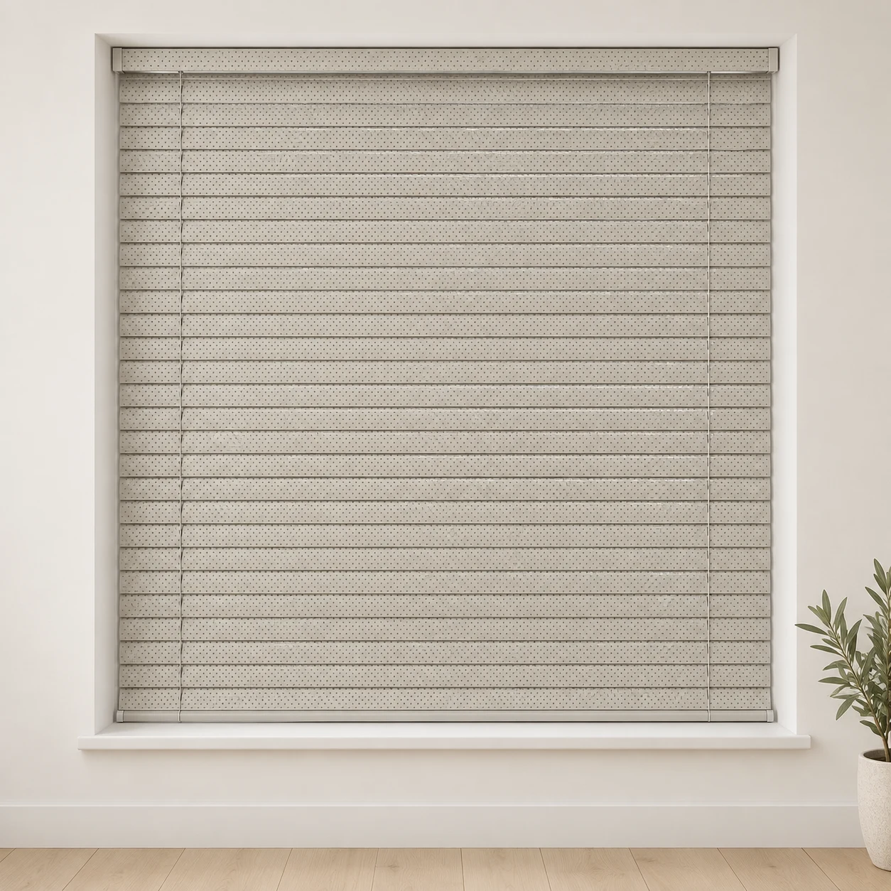 Perforated Cream shown as a full blind in a neutral room